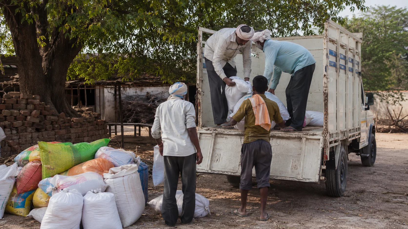 Agricultural inputs being loaded onto a delivery truck for rural distribution